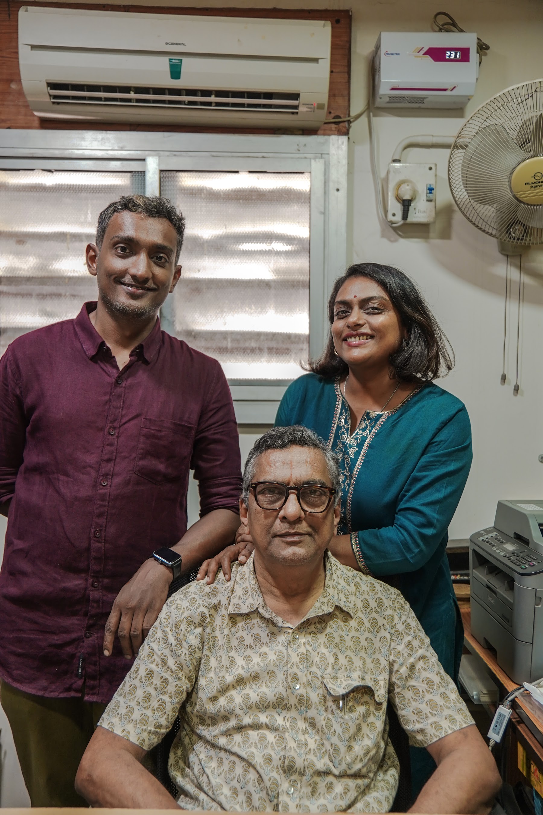 Three generations of the family in the workshop office, the eldest seated